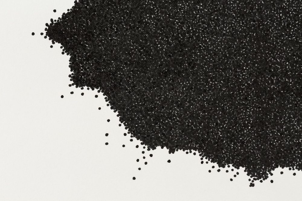 A close up of a section of a black ink drawing composed of numerous small spheres